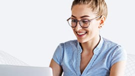 Young woman with glasses using laptop