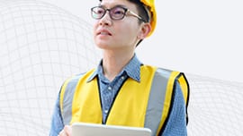 Construction worker with yellow vest on a tablet